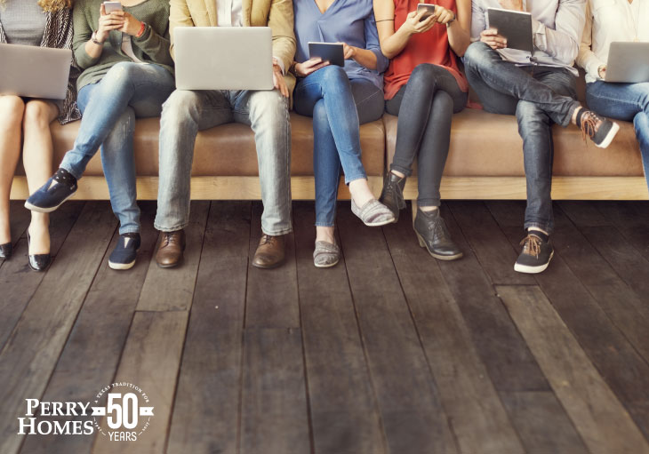 couch full of people using phones, tablets and laptop computers